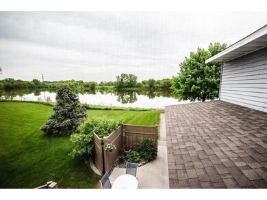 A large pond is situated just beyond the townhome.