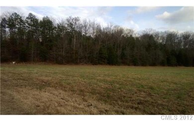 Land - Flat acreage surrounded by woods.