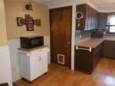 Another view of kitchen and access to basement.