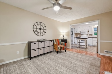 Living area with light wood-style floors, a ceilin
