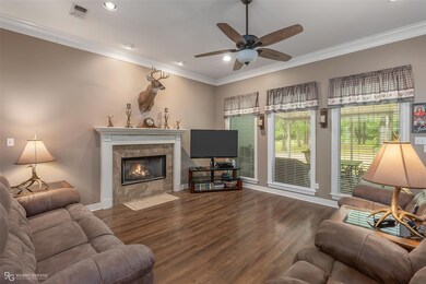 Living room featuring crown molding, dark wood-typ