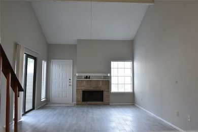 wood-look tile flooring, brick-surrounded fireplace w/mantel
