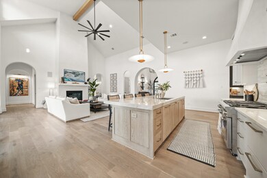 This wide open space is great for entertaining. The white oak kitchen island has storage all around with outlets.
