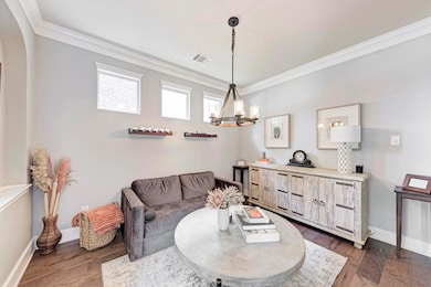 Living room with crown molding, dark wood finishe