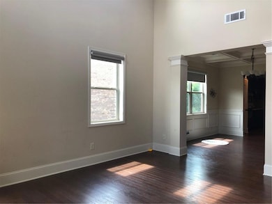 Unfurnished room featuring visible vents, baseboar