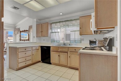 Kitchen featuring dishwasher, light brown cabinetry, a peninsula, ornamental molding, and light countertops