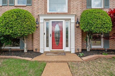 Entrance to property featuring brick siding
