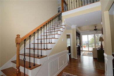 Beautiful entry way w/ hardwood stairs & wrought i