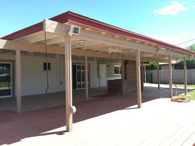 Enormous covered patio and BBQ-smoker wi