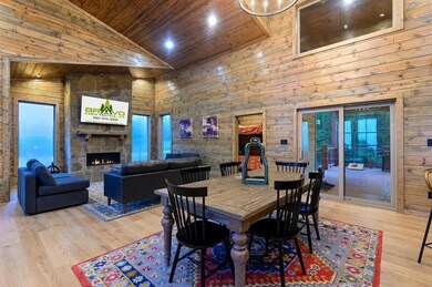 Dining area featuring a fireplace, wood ceiling, h