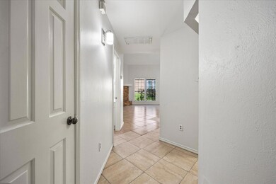 Hallway with light tile floors