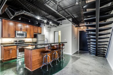 Kitchen with a high ceiling, appliances with stain