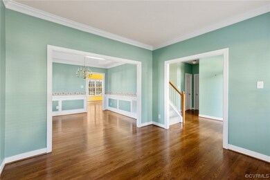 Formal living room off of the foyer w/ crown moldi