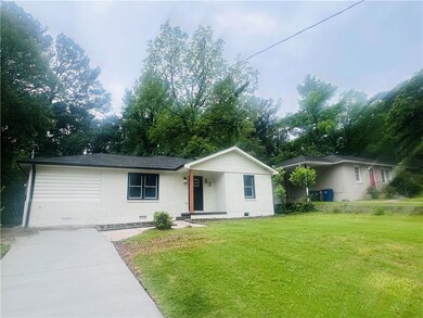 Ranch-style house with a front lawn, brick siding, and crawl space