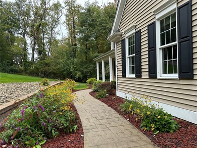 Perrenial flowers line the stamped concrete front