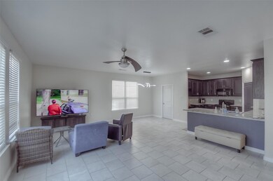 Tiled living room featuring ceiling fan