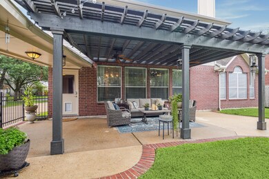Spacious brick lined patio and iron fence to drive