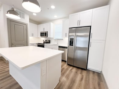 Kitchen with light hardwood / wood-style flooring,
