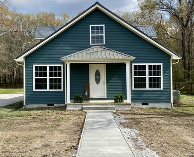 New front sidewalk leads to the covered front porch.  