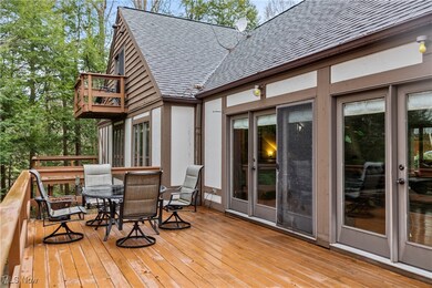 Wooden terrace with outdoor dining space and french doors