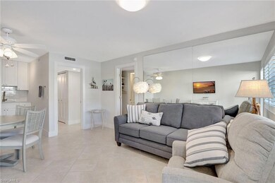 Living room featuring ceiling fan and light tile p