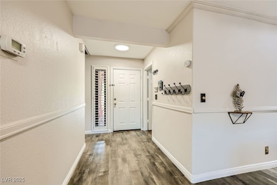 Corridor featuring wood finished floors, baseboard