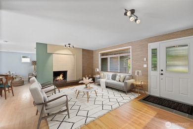 Cozy evenings by the fire in a warm, welcoming living space. Inviting living room with fireplace and open layout.