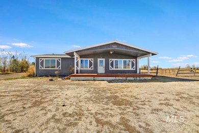 Rear view of property with covered porch