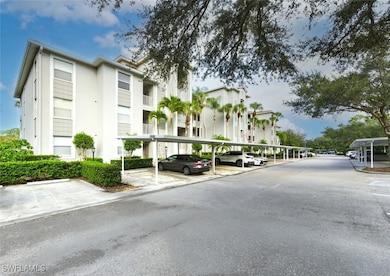 View of building exterior featuring covered parking