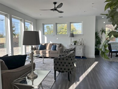 Living area with dark wood-type flooring, baseboa