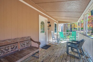 Covered front porch has just been power washed.  View of gorgeous landscaped flower beds.