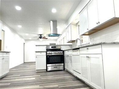 Kitchen featuring island range hood, hardwood / wo