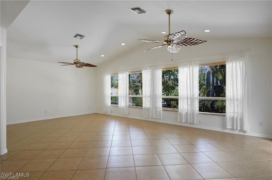 Spare room with ceiling fan, light tile patterned