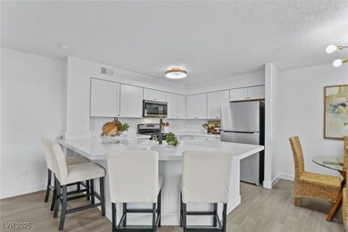 Kitchen with visible vents, a breakfast bar area,