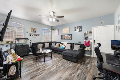 Living area featuring an office area, wood finished floors, and a ceiling fan