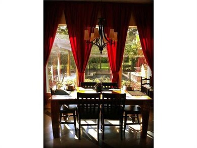 Breakfast Room. wall of windows overlooking pool,