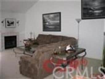 Wood burning fireplace. Area behind the couch was 