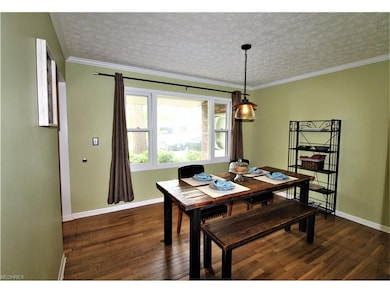 Formal Dining Room with Hardwood Floor and Crown M