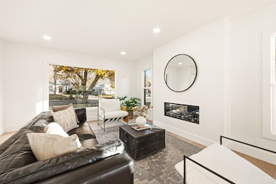 Living room featuring a fireplace, recessed lighting, and wood finished floors