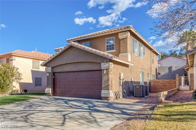 View of front facade with stucco siding, driveway,