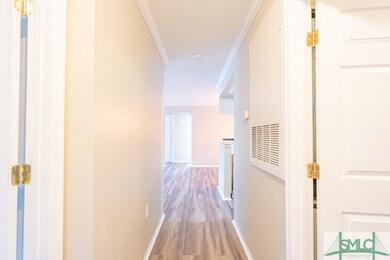 Entrance, hallway leads to living room. Laundry room on the immediate right