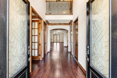 2 story entry with wood flooring throughout the fi