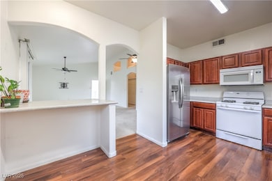 Kitchen with light countertops, a ceiling fan, whi