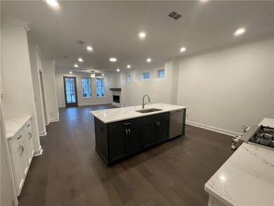 Beautiful hardwood floors throughout except for the bedroom. This lovely kitchen features Cambria counter tops and GE stainless appliances! Not actual home.