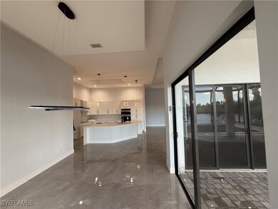 Kitchen with backsplash, decorative light fixtures