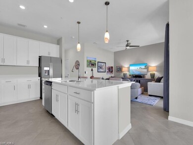 Kitchen featuring stainless steel appliances, ceiling fan, light tile patterned floors, white cabinets, and recessed lighting