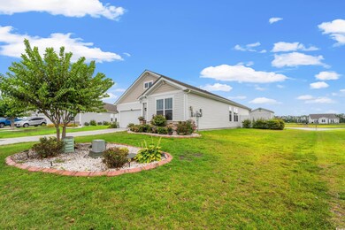 View of property exterior with a garage and a yard