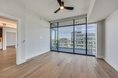 Unfurnished room featuring a wall of windows, ligh