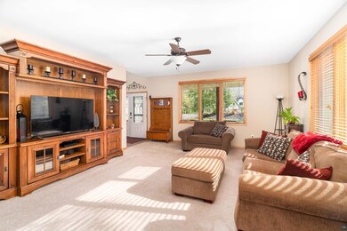 Living room featuring ceiling fan and light colore