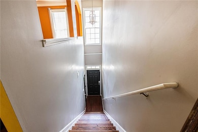 Stairs with baseboards and wood finished floors